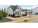 Attractive home featuring a manicured front lawn, a comfortable front porch, and timeless architectural style at 1024 Traditions Ridge Dr, Wake Forest, NC 27587