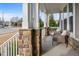 Inviting porch with stone accents, white railings, seating, and view of neighborhood street at 1024 Traditions Ridge Dr, Wake Forest, NC 27587