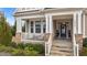 Charming front porch featuring stone pillars, a white railing, and a welcoming entrance to the home at 1024 Traditions Ridge Dr, Wake Forest, NC 27587