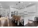 Eat-in kitchen boasts white cabinets, an island with seating, and stainless appliances at 1024 Traditions Ridge Dr, Wake Forest, NC 27587