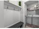 Mudroom and laundry room features a bench, coat hooks, and laundry machines at 1024 Traditions Ridge Dr, Wake Forest, NC 27587