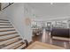Open-concept living space with stairs, dining area, kitchen, and comfortable seating, ideal for entertaining at 1024 Traditions Ridge Dr, Wake Forest, NC 27587