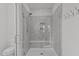 Modern glass shower with gray tiling and bench, with adjacent toilet at 1024 Traditions Ridge Dr, Wake Forest, NC 27587
