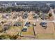 Aerial view of homes in a quiet neighborhood showing spacious lots and serene surroundings with mature trees at 103 Poplar Dr, Clayton, NC 27520