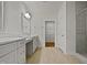 Bright bathroom featuring double vanity, quartz countertop and a walk-in closet at 10330 Sablewood Dr # 103, Raleigh, NC 27617