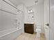 Bathroom featuring a tub-shower combo, updated vanity, and tile flooring at 10330 Sablewood Dr # 103, Raleigh, NC 27617
