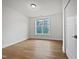 Bright, airy bedroom with hardwood floors and a window offering neighborhood views at 10330 Sablewood Dr # 103, Raleigh, NC 27617