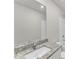 Modern bathroom features a granite countertop, sleek sink, and a pristine white shower-tub combo at 104 Wilderness Ct, Mebane, NC 27302
