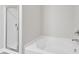 Bathroom with a tub, shower with glass door, faucet, and neutral wall paint at 104 Wilderness Ct, Mebane, NC 27302