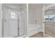 Bathroom with a shower, soaking tub, and bright window at 104 Wilderness Ct, Mebane, NC 27302