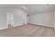 Large open bedroom with carpeted floors, neutral walls, and two entry doors at 104 Wilderness Ct, Mebane, NC 27302