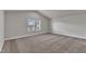 This bedroom has neutral walls and carpet, vaulted ceiling, with a bright window at 104 Wilderness Ct, Mebane, NC 27302