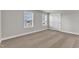 Bedroom featuring carpet, neutral walls, and two windows, providing a bright and airy space at 104 Wilderness Ct, Mebane, NC 27302