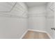 Walk in closet with multiple shelves and neutral carpet at 104 Wilderness Ct, Mebane, NC 27302