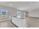 Open kitchen island with stainless dishwasher overlooks the spacious living area at 104 Wilderness Ct, Mebane, NC 27302
