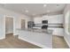 Bright kitchen features granite countertops, stainless appliances, and white cabinets at 104 Wilderness Ct, Mebane, NC 27302