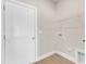 Clean, spacious laundry room with white door, utility hookups and shelving at 104 Wilderness Ct, Mebane, NC 27302