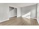 Spacious living room with wood floors, neutral paint, white trim, and natural light coming from multiple windows at 104 Wilderness Ct, Mebane, NC 27302