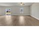 Open living space featuring hardwood floors, sliding glass doors, and a window at 104 Wilderness Ct, Mebane, NC 27302