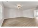Bright living room with hardwood floors, a ceiling fan, and a view of the entry door at 104 Wilderness Ct, Mebane, NC 27302