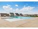 A community pool offers residents a refreshing outdoor retreat with suburban homes visible in the background at 104 Wilderness Ct, Mebane, NC 27302