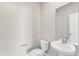 Neutral powder room with pedestal sink, toilet, and mirror at 104 Wilderness Ct, Mebane, NC 27302