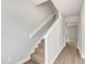 Carpeted staircase with white railing and trim, leading to the upper level with natural light at 104 Wilderness Ct, Mebane, NC 27302