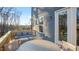 A well appointed back deck with a patio set, comfortable seating, and views of the wooded backyard at 10620 Pleasant Branch Dr # 9, Raleigh, NC 27614