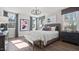 Sunlit bedroom with hardwood floors, a modern chandelier, and neutral decor creating a peaceful ambiance at 10620 Pleasant Branch Dr # 9, Raleigh, NC 27614