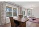 Bright dining area with hardwood floors, large windows, stylish curtains, and comfortable seating at 10620 Pleasant Branch Dr # 9, Raleigh, NC 27614