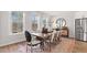 Inviting dining room filled with natural light, adjacent to a stainless steel refrigerator at 10620 Pleasant Branch Dr # 9, Raleigh, NC 27614