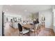 Bright dining area showcasing wood floors and an adjacent living space and powder room at 10620 Pleasant Branch Dr # 9, Raleigh, NC 27614