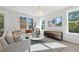 Bright living room with a cozy sectional sofa, hardwood floors, and natural light from several windows at 10620 Pleasant Branch Dr # 9, Raleigh, NC 27614