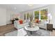 Open living room featuring natural light from windows, hardwood floors, neutral sofa, and decorative accents at 10620 Pleasant Branch Dr # 9, Raleigh, NC 27614