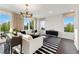 Well-lit living room boasting large windows, contemporary chandelier, white sofa, and chic black and white striped rug at 10622 Pleasant Branch Dr # 8, Raleigh, NC 27614