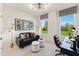 Bright home office with neutral colors, large windows, and comfortable seating for working from home at 10622 Pleasant Branch Dr # 8, Raleigh, NC 27614