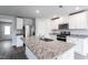 Well-equipped kitchen with granite counters, stainless steel appliances, and island at 109 Wilderness Ct, Mebane, NC 27302