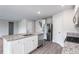 Modern kitchen featuring granite countertops, stainless steel appliances, and white cabinets at 109 Wilderness Ct, Mebane, NC 27302