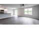 Open-concept living room with vinyl floors, ceiling fan, granite countertops and stainless-steel appliances at 109 Wilderness Ct, Mebane, NC 27302