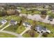 Aerial view of a home near the water, showcasing its landscaped yard, long driveway, and neighborhood at 123 Glasgow Dr, Clayton, NC 27520