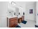 Ensuite bathroom with double vanities, large mirror, and tiled walk-in shower at 123 Glasgow Dr, Clayton, NC 27520