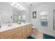 Well-lit bathroom featuring a double vanity, framed mirror, and tile flooring at 123 Glasgow Dr, Clayton, NC 27520