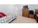 Bedroom featuring patterned bedding, dresser, and TV at 123 Glasgow Dr, Clayton, NC 27520