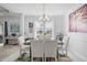 Dining room with chandelier, large windows and neutral colored rug at 123 Glasgow Dr, Clayton, NC 27520