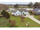 Beautiful lakefront home featuring white siding, blue shutters, mature landscaping, and a long driveway at 123 Glasgow Dr, Clayton, NC 27520