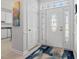 Bright foyer featuring a decorative glass front door, white trim, and a colorful area rug at 123 Glasgow Dr, Clayton, NC 27520