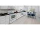 Well-lit kitchen featuring white cabinets, countertops, and stainless steel appliances at 123 Glasgow Dr, Clayton, NC 27520