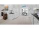 Bright kitchen with white cabinets and stainless steel appliances, opening to dining area at 123 Glasgow Dr, Clayton, NC 27520