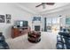 Bright living room with a fireplace, entertainment center, and access to an outdoor patio at 123 Glasgow Dr, Clayton, NC 27520