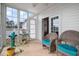 Inviting sunroom featuring wicker chairs, large windows, and tile flooring at 123 Glasgow Dr, Clayton, NC 27520
